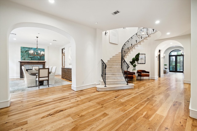 interior space featuring an inviting chandelier and light hardwood / wood-style flooring