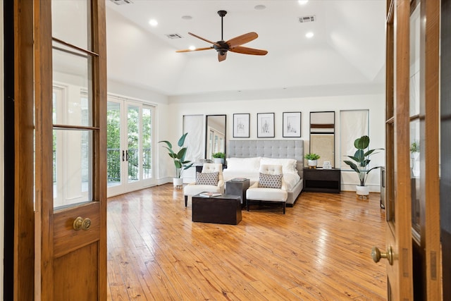 living room with ceiling fan, light wood-type flooring, and vaulted ceiling