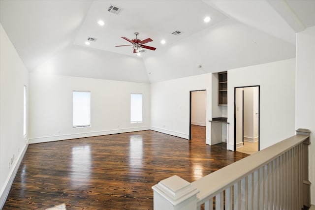 unfurnished living room featuring ceiling fan, dark hardwood / wood-style floors, and lofted ceiling