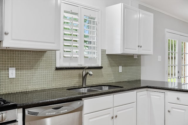 kitchen with stainless steel dishwasher, backsplash, white cabinetry, sink, and crown molding