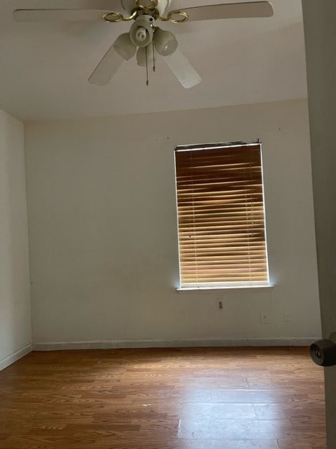 spare room featuring ceiling fan and hardwood / wood-style flooring