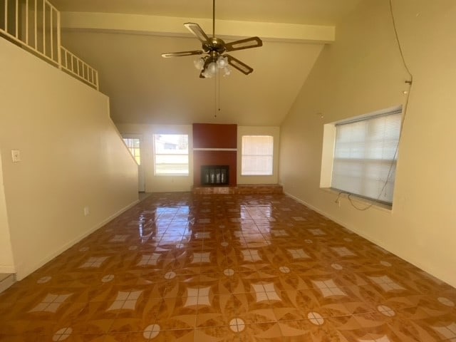 additional living space with ceiling fan, high vaulted ceiling, tile patterned flooring, and beam ceiling