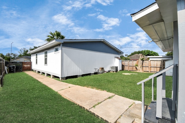 exterior space with cooling unit and a yard