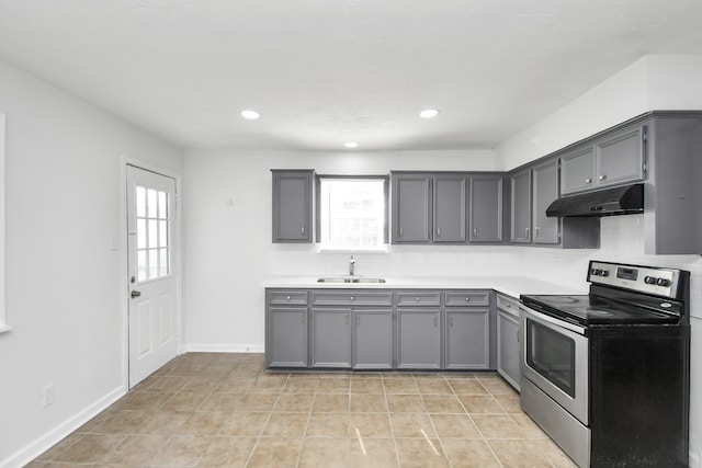 kitchen featuring light tile patterned floors, sink, stainless steel range with electric stovetop, and gray cabinetry