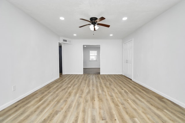 empty room with ceiling fan and light wood-type flooring