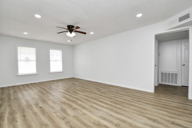 spare room with ceiling fan and light hardwood / wood-style flooring