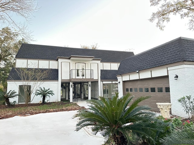 view of front of house with a garage and a balcony