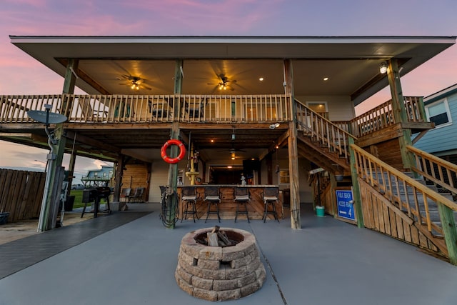 back of property featuring a patio area, stairs, a fire pit, and outdoor dry bar