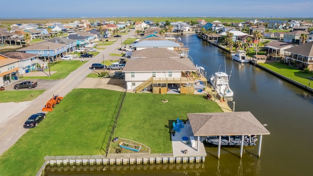 drone / aerial view featuring a water view and a residential view