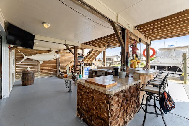 view of patio / terrace with stairs and outdoor dry bar