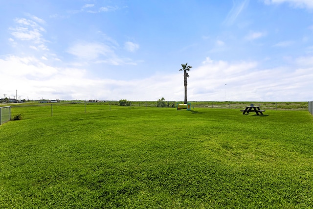 view of yard with a rural view and fence