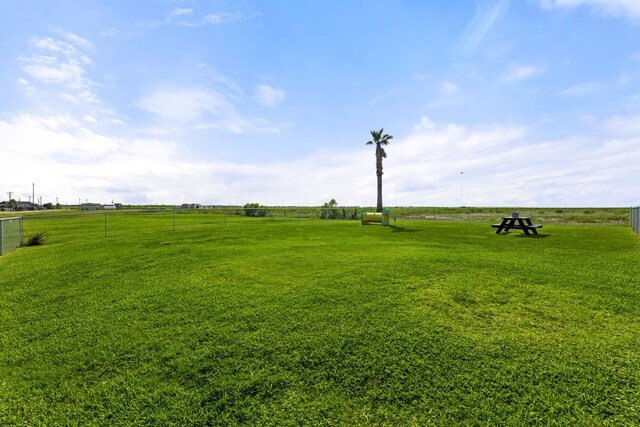 view of yard featuring a rural view and fence