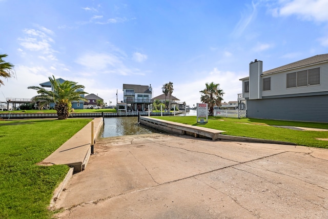 surrounding community featuring a water view and a lawn