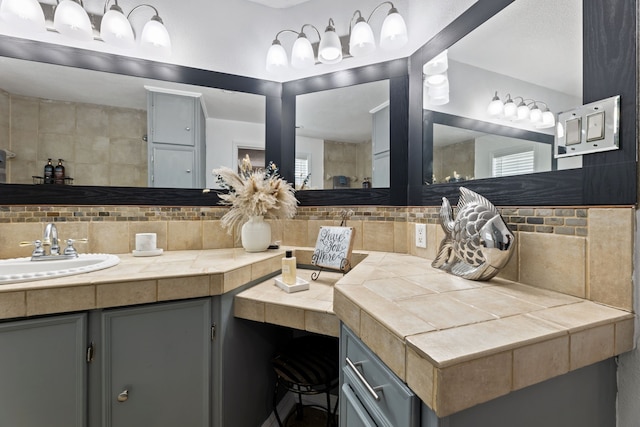 bathroom with tasteful backsplash and vanity