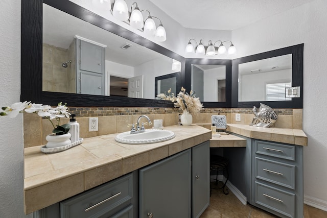 full bathroom with tasteful backsplash, visible vents, vanity, and tile patterned floors