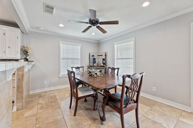 dining area with ornamental molding, a wealth of natural light, visible vents, and baseboards