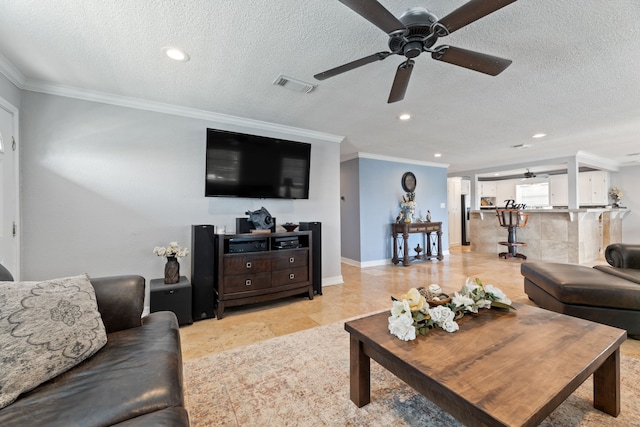 living area featuring a textured ceiling, ornamental molding, visible vents, and recessed lighting