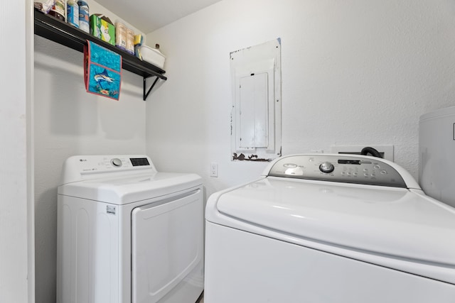 laundry area featuring laundry area, washing machine and dryer, and electric panel