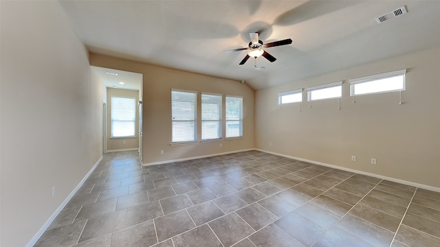 tiled empty room with ceiling fan and a healthy amount of sunlight