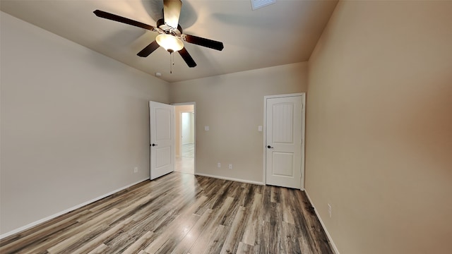 unfurnished bedroom featuring a ceiling fan, baseboards, and wood finished floors