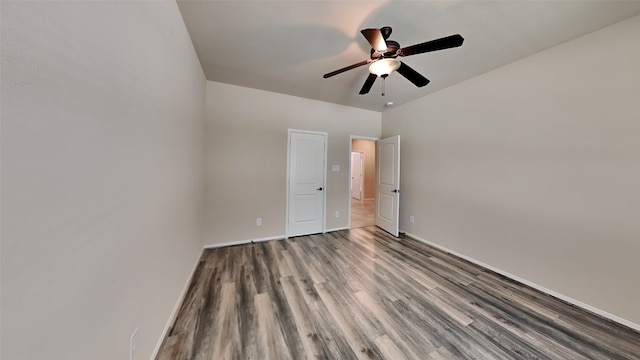 unfurnished bedroom featuring wood finished floors, a ceiling fan, and baseboards