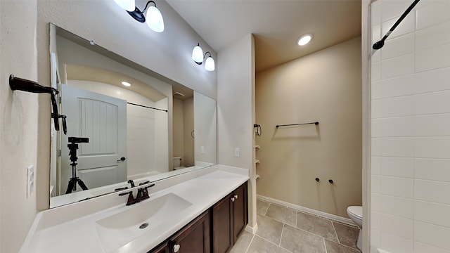 full bathroom with recessed lighting, toilet, vanity, baseboards, and tile patterned floors