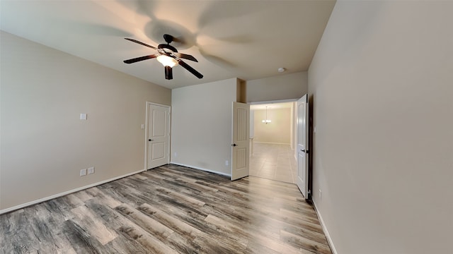 unfurnished bedroom featuring wood finished floors, a ceiling fan, and baseboards