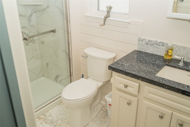 bathroom featuring vanity, toilet, and a shower with shower door