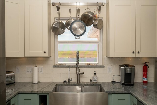 kitchen featuring white cabinetry, a healthy amount of sunlight, and sink