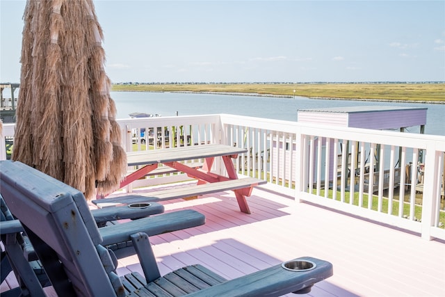 wooden terrace featuring a water view