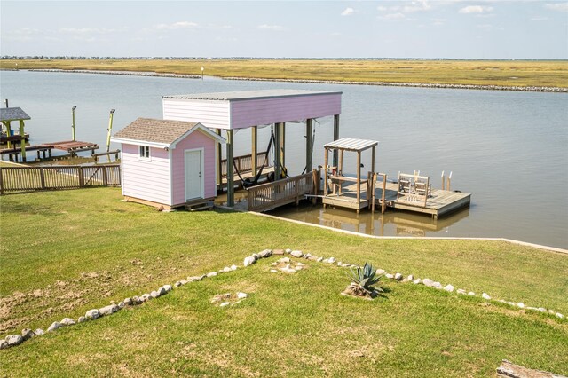 dock area featuring a yard and a water view