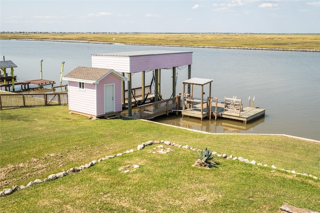 view of dock featuring a water view, a yard, and boat lift