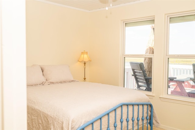 bedroom with crown molding and baseboards