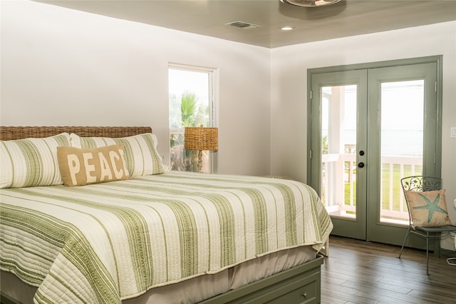 bedroom with french doors, multiple windows, access to outside, and dark hardwood / wood-style flooring