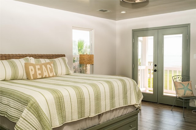 bedroom featuring access to exterior, french doors, visible vents, and dark wood-style flooring