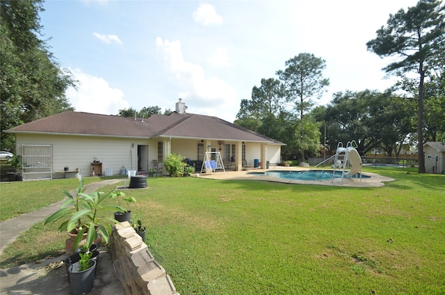 back of property featuring a patio area and a lawn