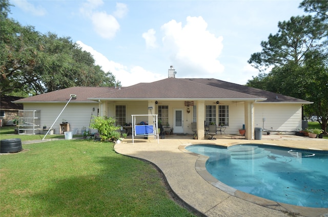 view of swimming pool with a patio and a yard