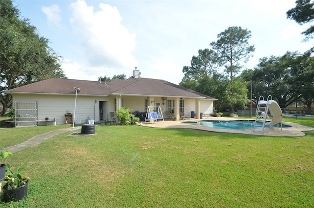 back of house with a lawn and a patio area