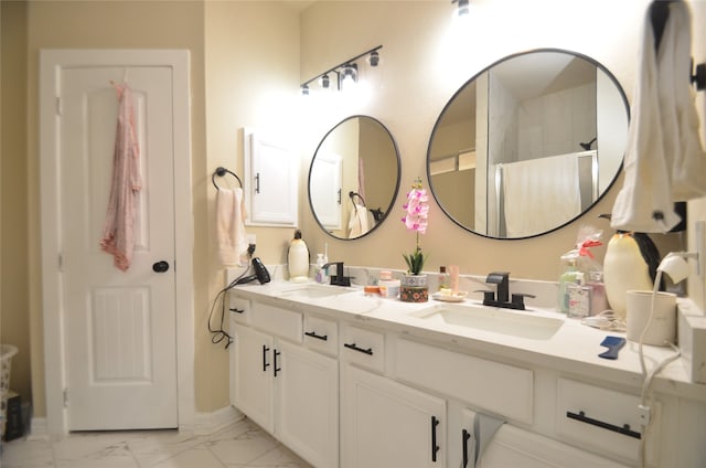 bathroom with tile patterned flooring and vanity