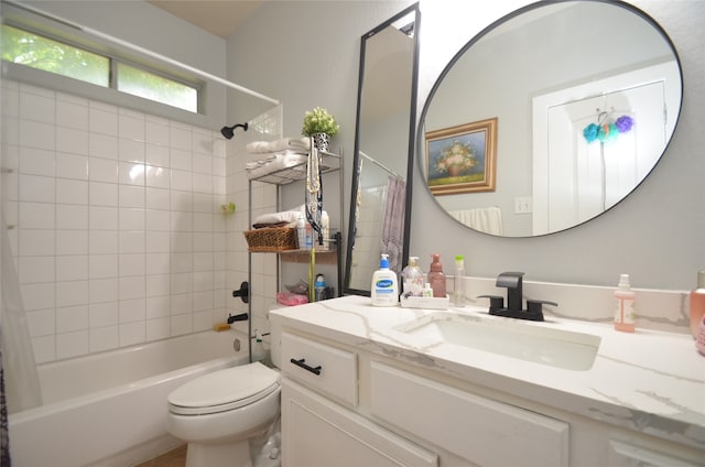 full bathroom with tiled shower / bath combo, toilet, and vanity