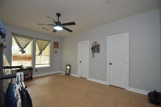 interior space with ceiling fan and light tile patterned floors