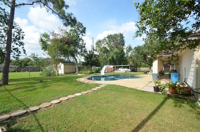 view of yard with a patio and a fenced in pool