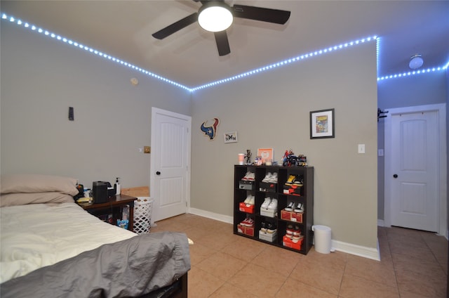 bedroom with ceiling fan and tile patterned floors