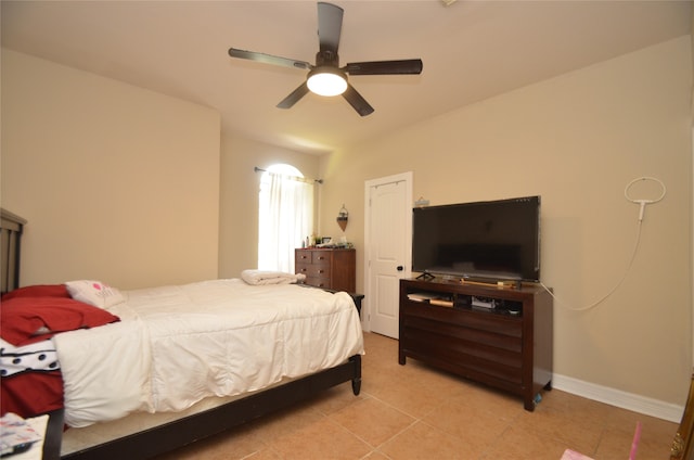 bedroom featuring light tile patterned floors and ceiling fan