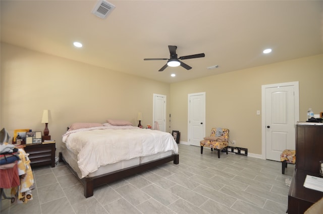 tiled bedroom featuring ceiling fan