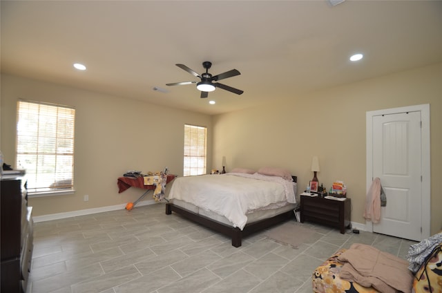 tiled bedroom featuring ceiling fan