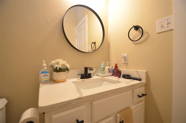 bathroom featuring toilet and vanity