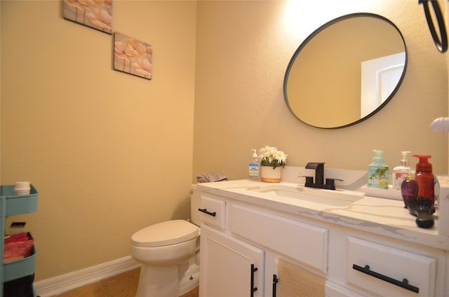 bathroom featuring tile patterned flooring, vanity, and toilet