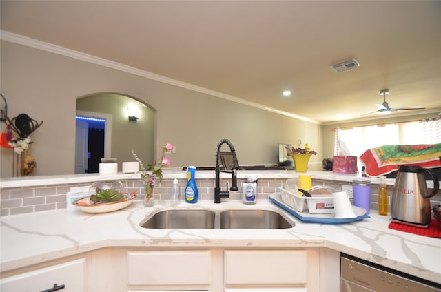 kitchen with ceiling fan, stainless steel dishwasher, white cabinets, light stone countertops, and sink