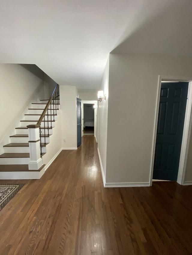 hall with dark hardwood / wood-style flooring